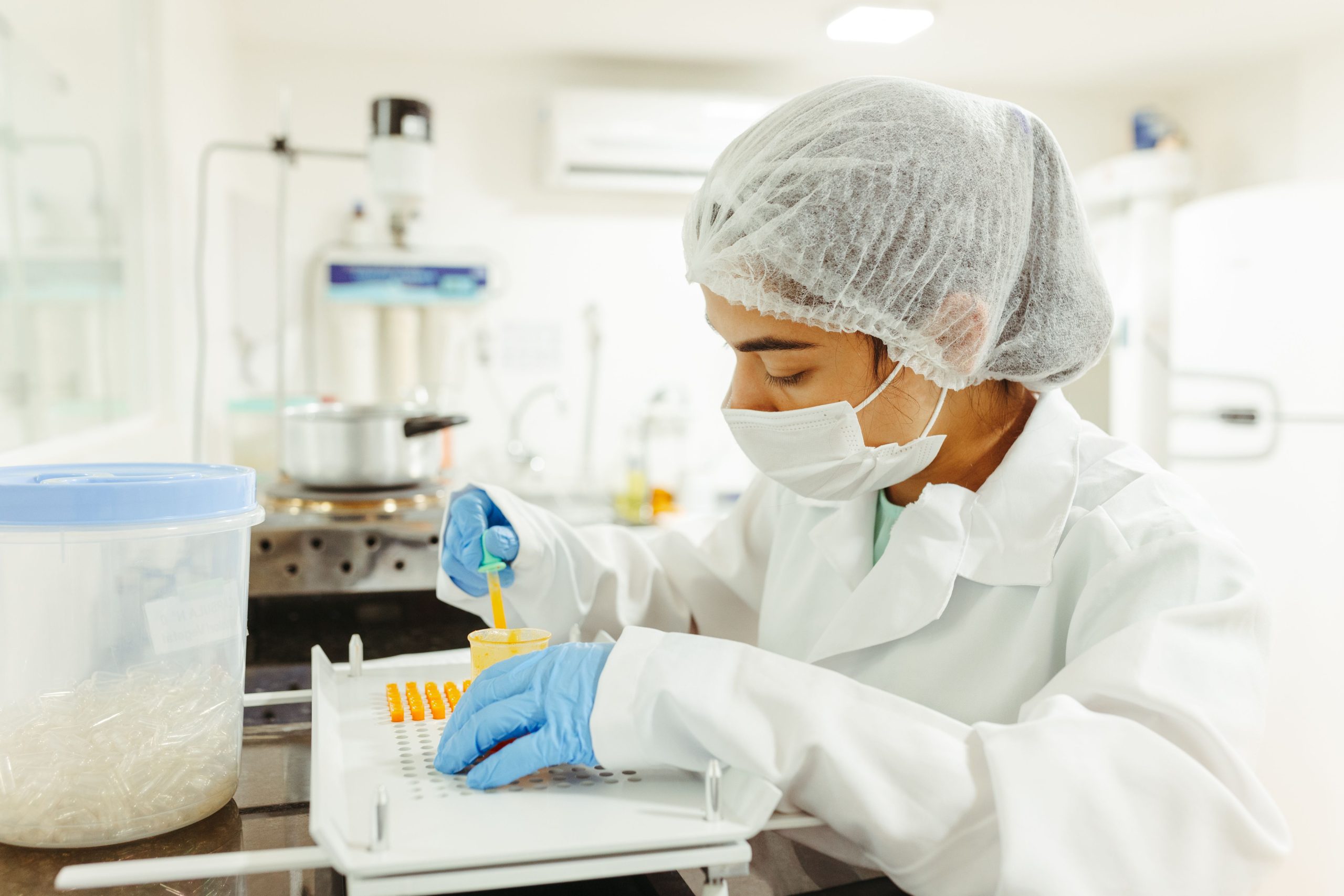 Lab technician performing technology transfer laboratory procedures