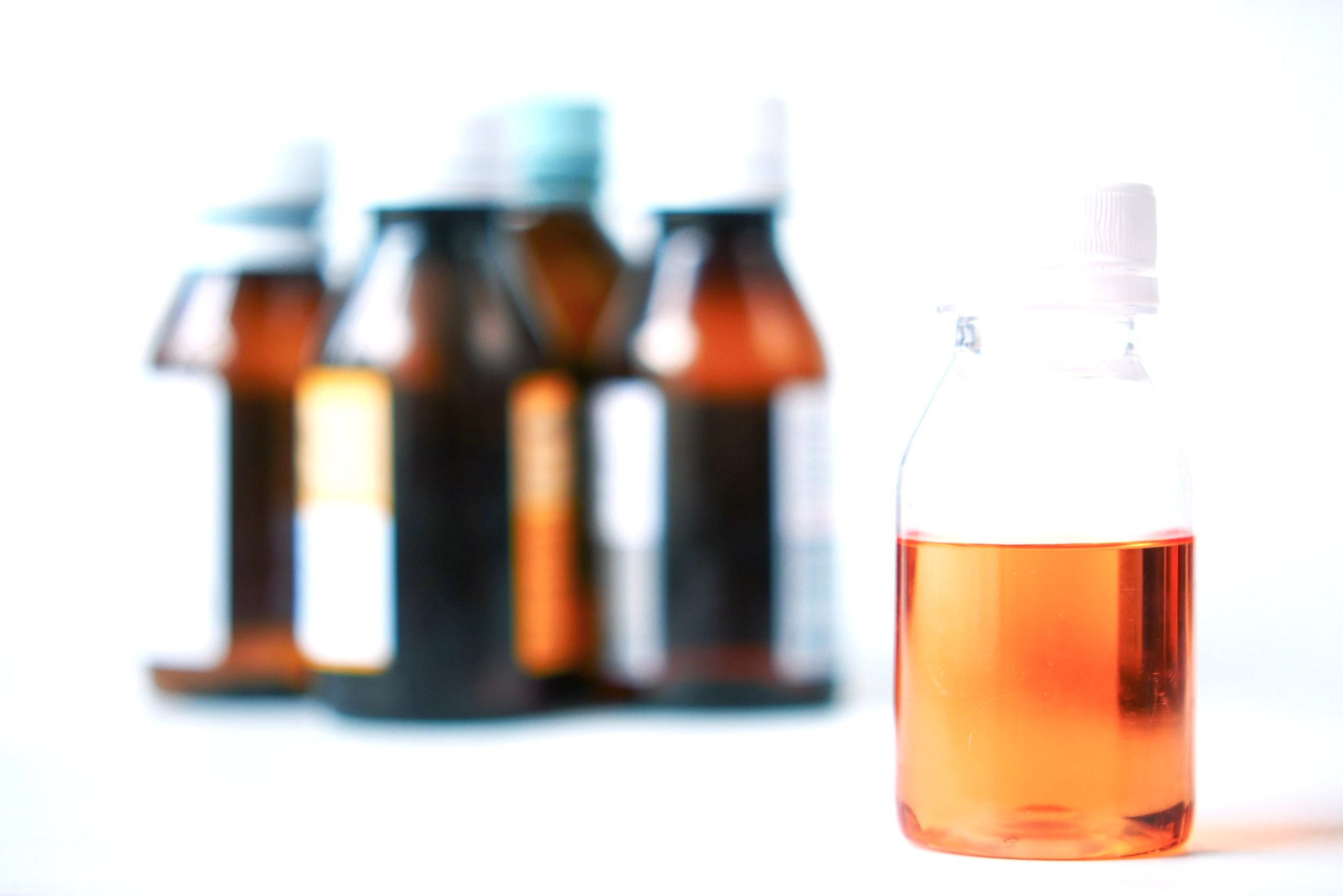 Amber oral solution bottles on a laboratory bench
